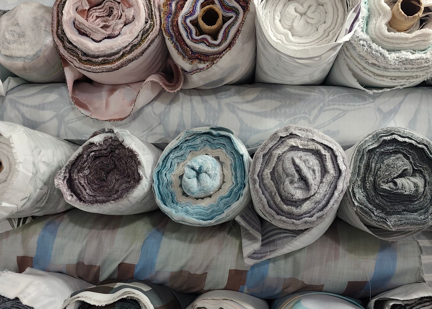 Nuclear Enterprises — textile fabric rolls stacked in the warehouse
